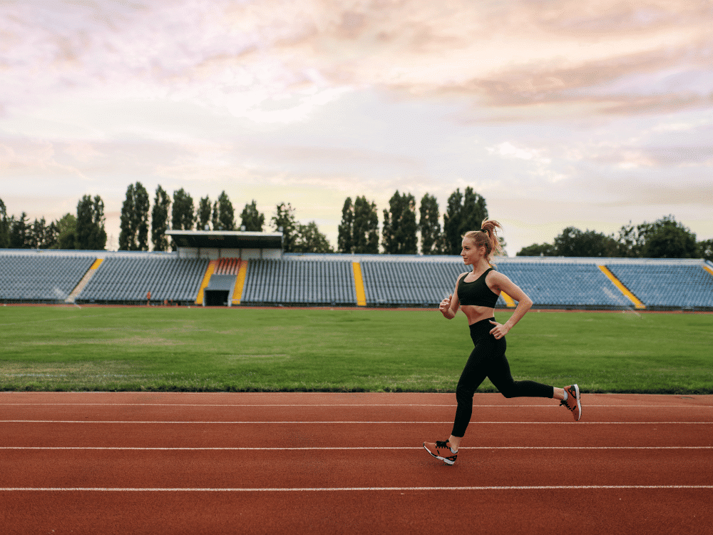 A girl is running on a running track